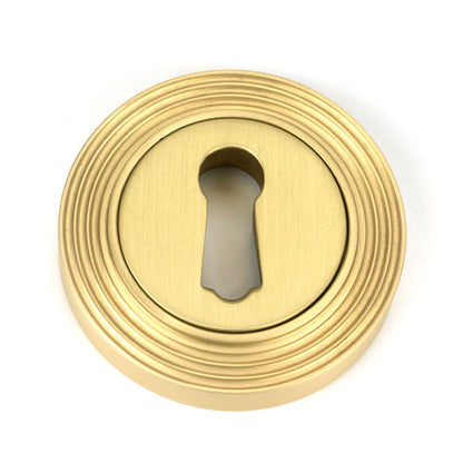 From The Anvil's Satin Brass Round Escutcheon