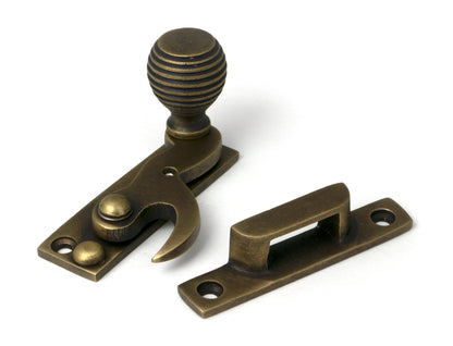 From The Anvil's Burnished Brass Beehive Sash Hook Fastener