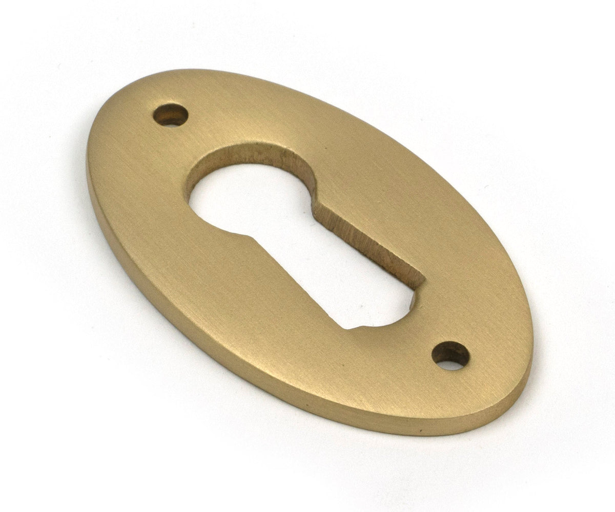 From The Anvil's Satin Brass Oval Escutcheon